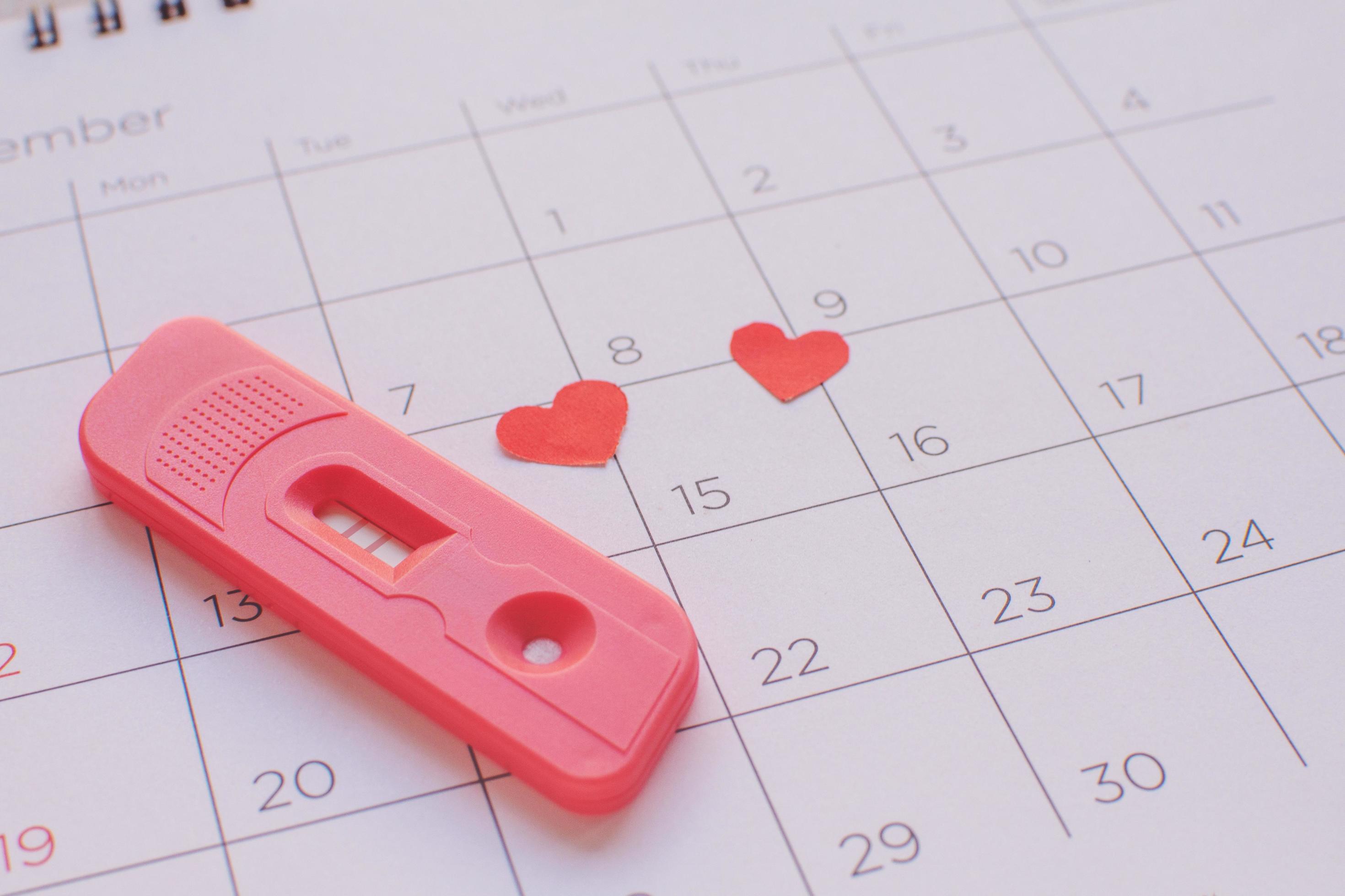 Pregnancy test on calendar background, health concept 7182736 Stock