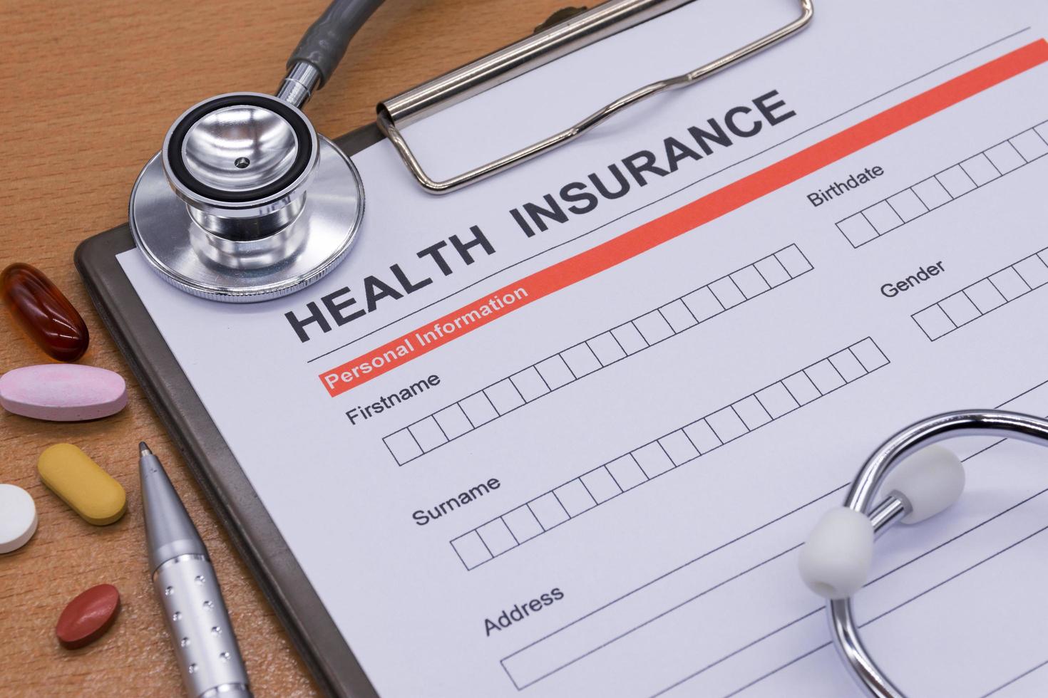 Health insurance paperwork, medicine, stethoscope. Health insurance claim concept. photo