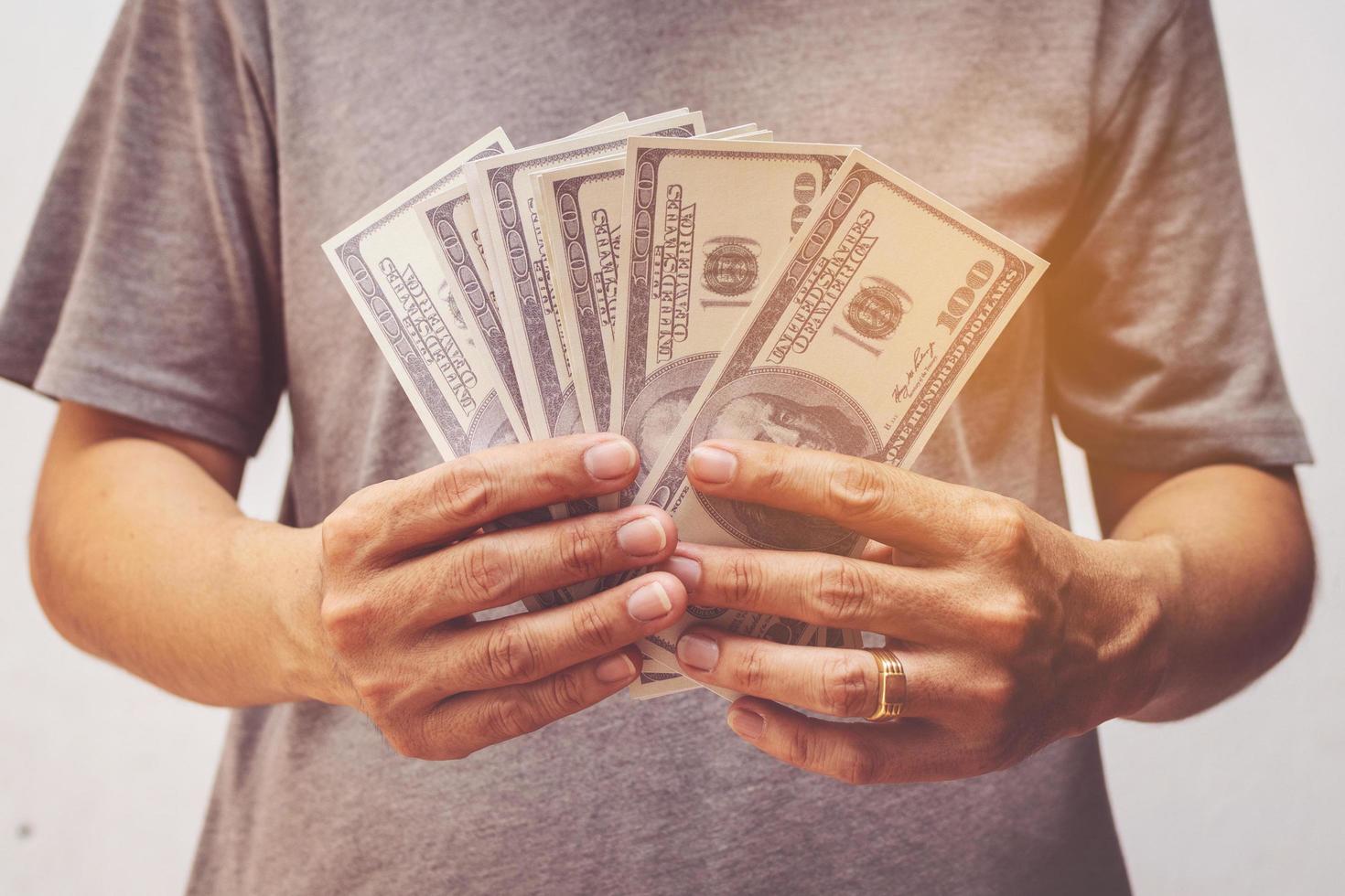 man showing bunch of dollars banknotes photo