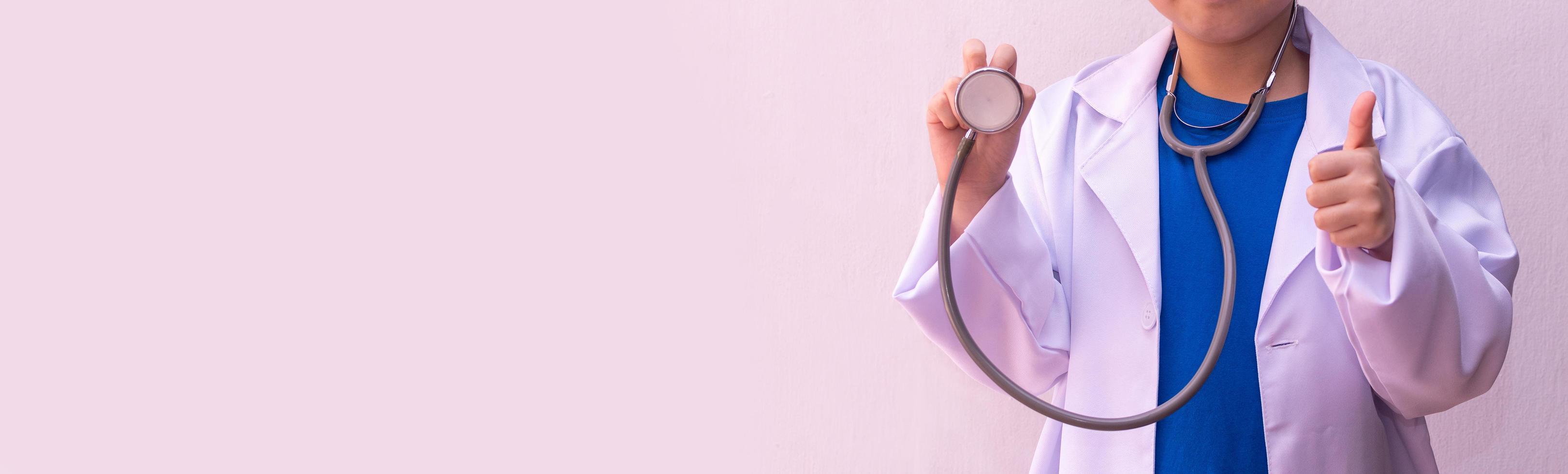 Asian girl playing doctor with stethoscope in hands. photo