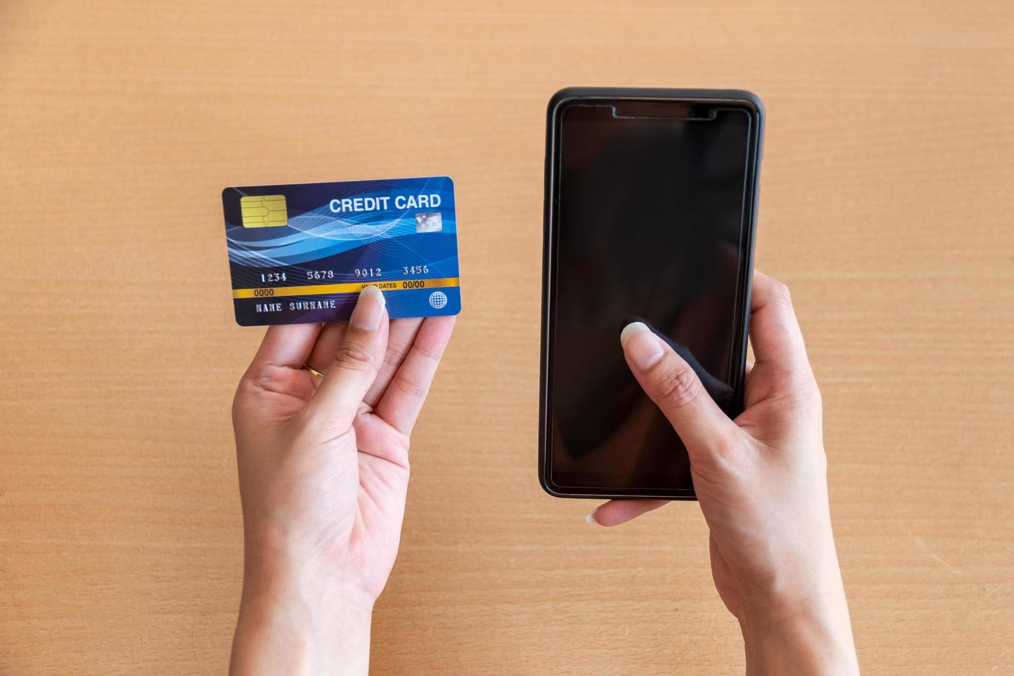 Woman holding credit card and smartphone. On-line shopping on the internet using a smartphone photo