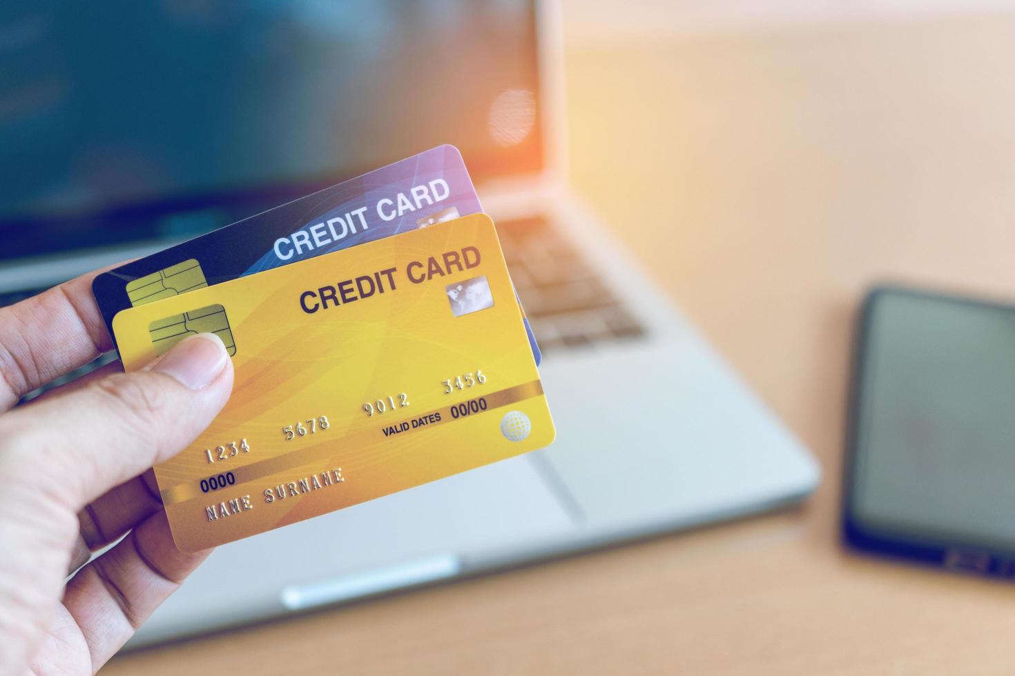 Man holding credit card on laptop. On-line shopping on the internet using a laptop photo