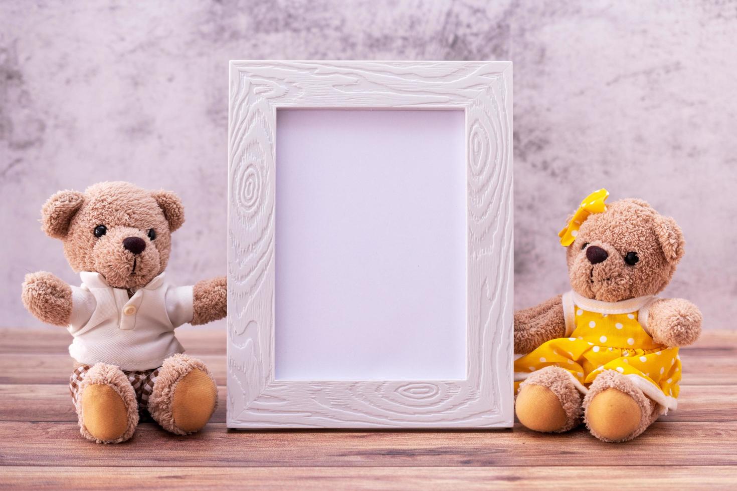 couple teddy bear with Picture frame on table wooden. Valentine's Day celebration photo