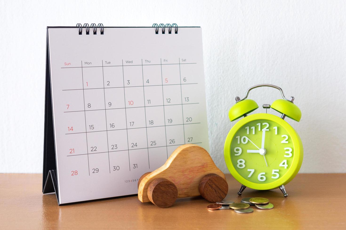 Calendar and car on table. Day of buying or selling a car or payment for rent or loan or repair photo