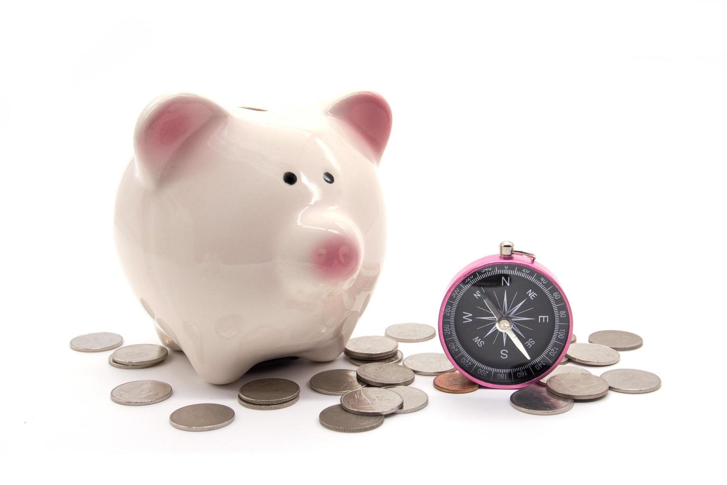 piggy bank with compass and coin on white background photo