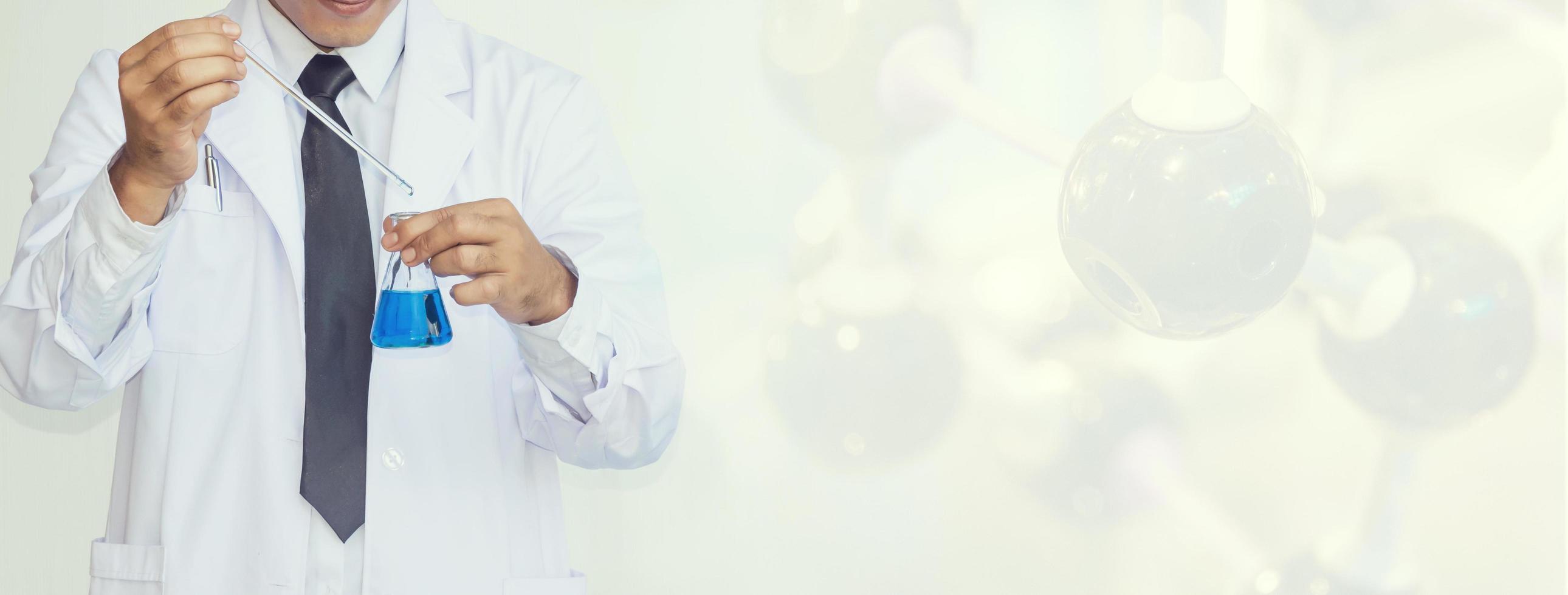 young man scientist in chemistry lab photo