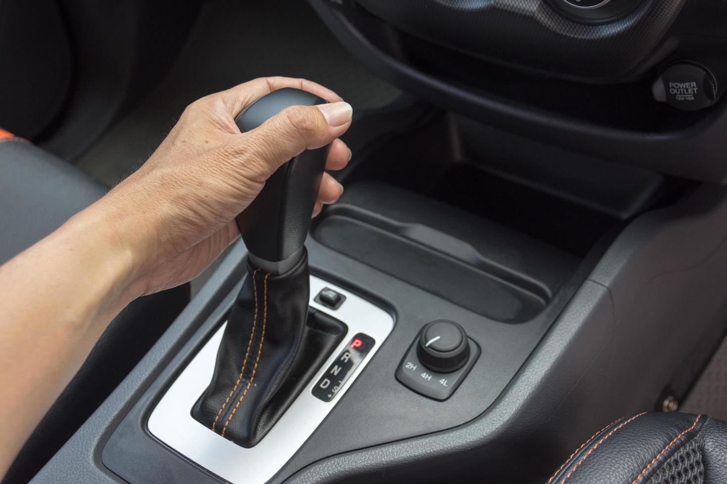 driver man hand holding automatic transmission in car photo