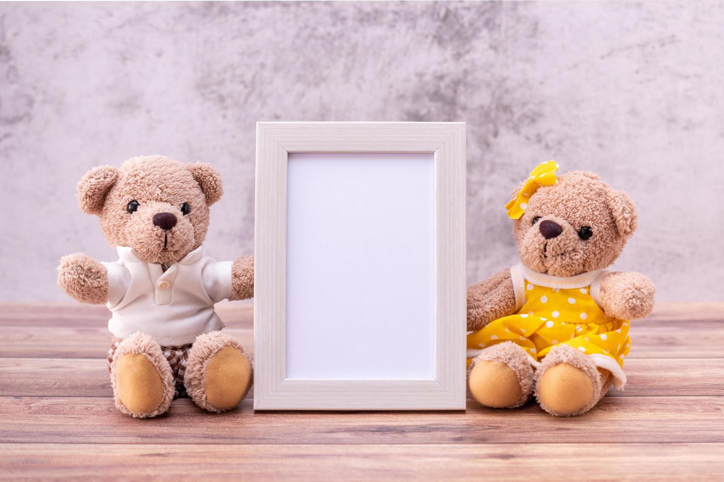 pareja oso de peluche con marco en la mesa de madera. celebración del día de san valentín foto