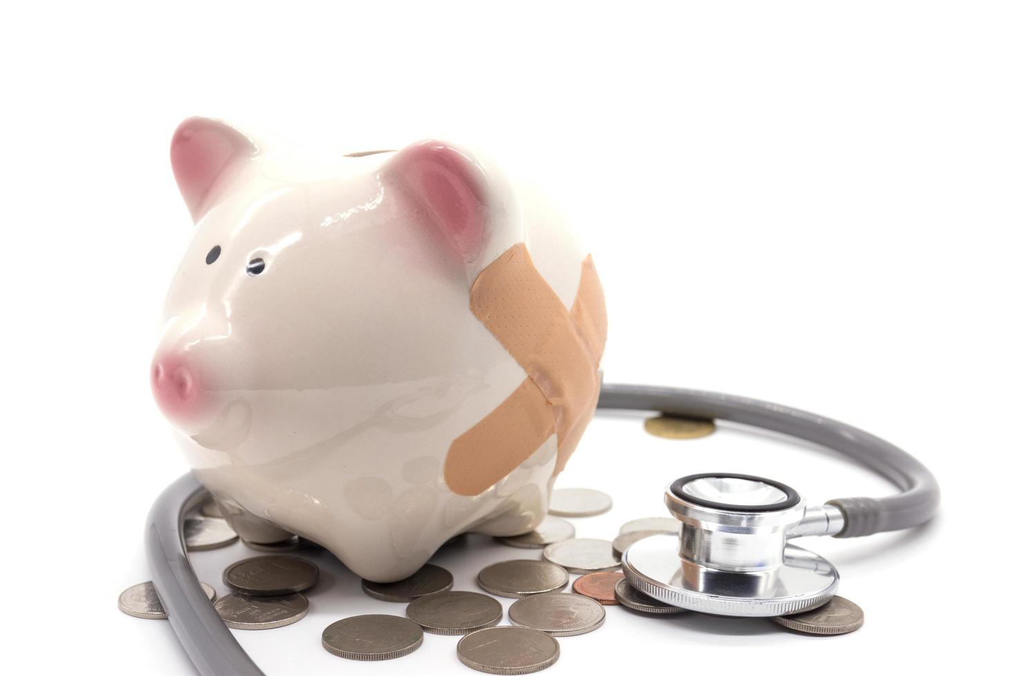 stethoscope with pink piggy bank and coins photo