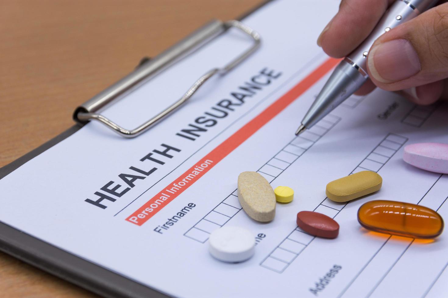 Health insurance paperwork, medicine, stethoscope. Health insurance claim concept. photo