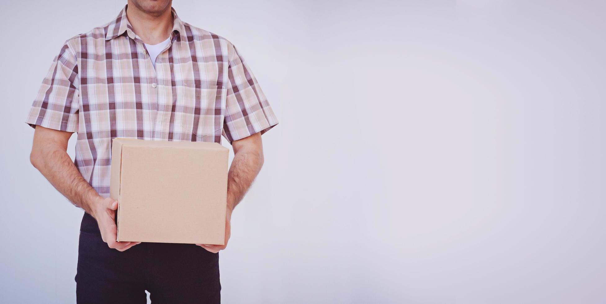 Asian young man holding box package, delivery man photo