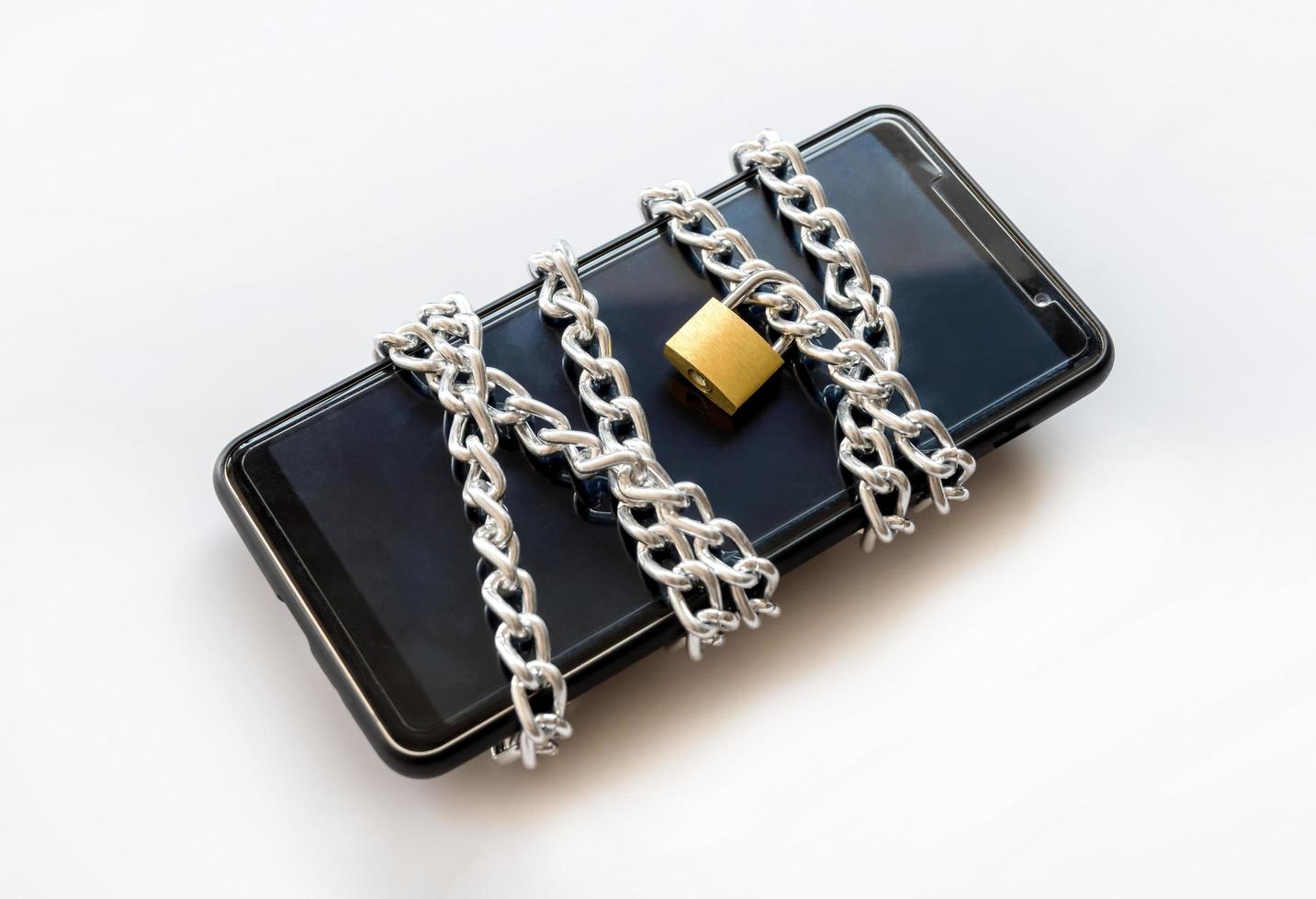 Smartphone with chain and padlock, Safety concept. photo