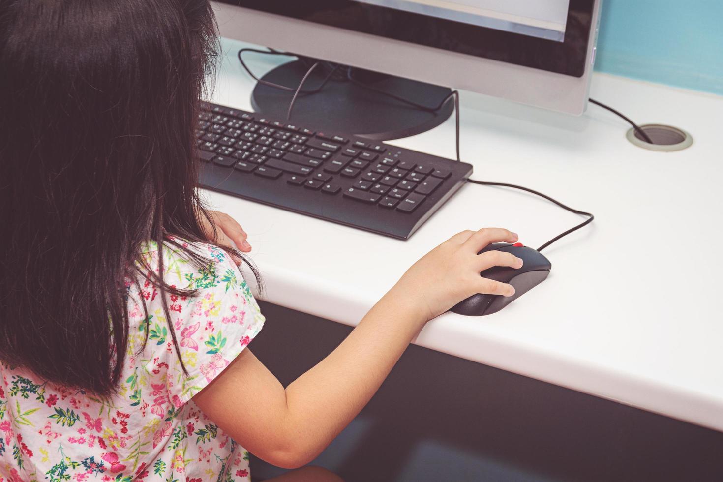 Girl playing with a computer photo