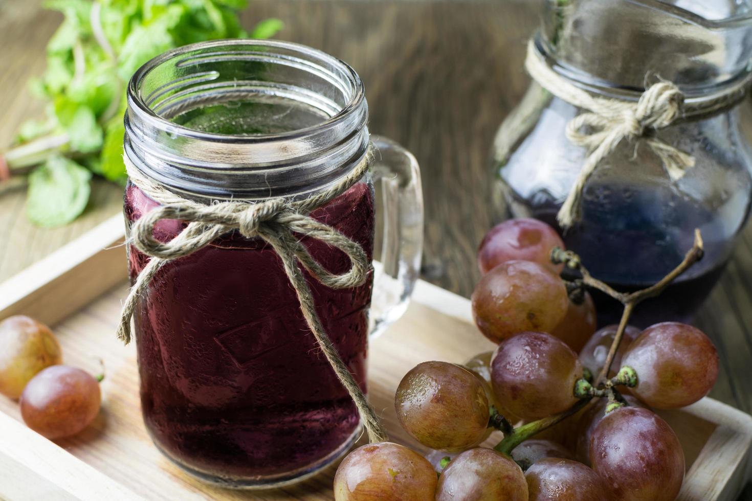 Fresh and juice grapes on wooden table photo