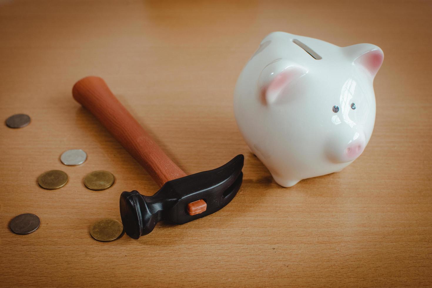 Little boy breaking a piggy bank photo