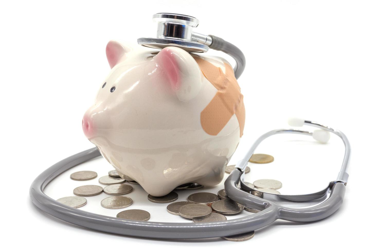 stethoscope with pink piggy bank and coins photo