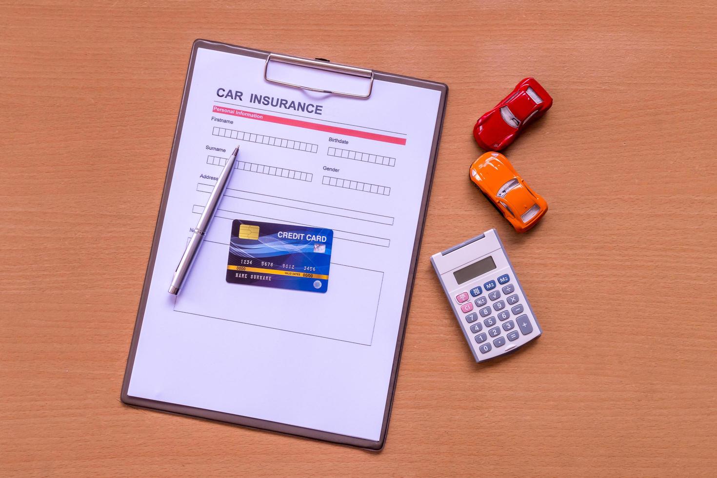 Car insurance form with model and policy document photo