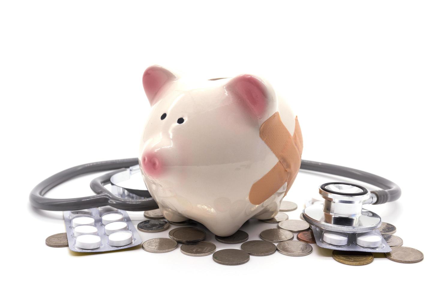 stethoscope with pink piggy bank and coins photo