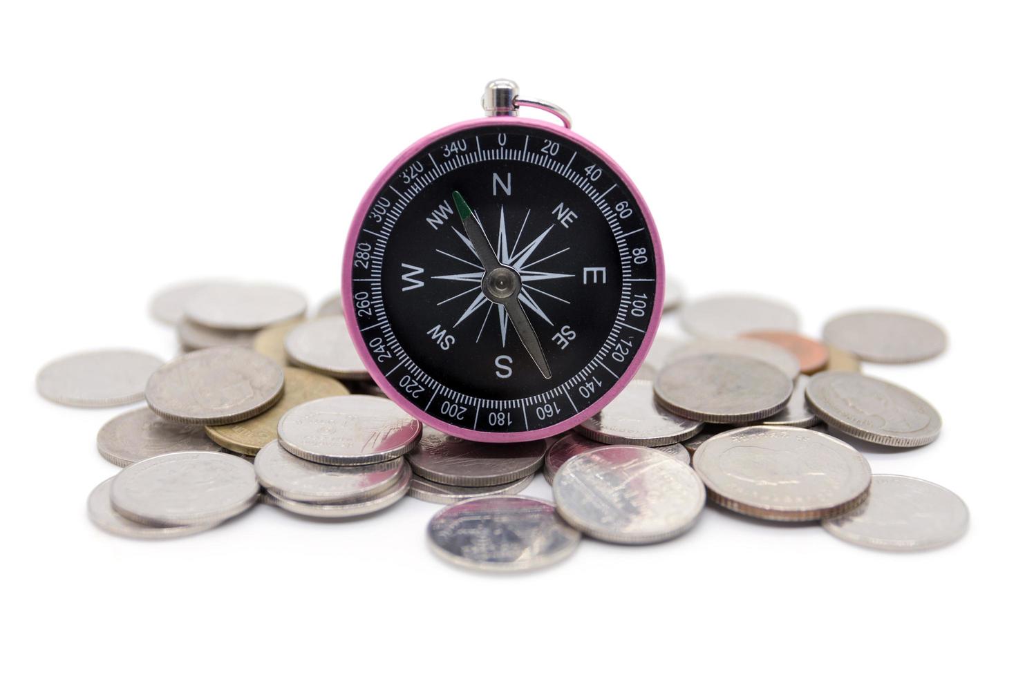 compass and coins on white background photo