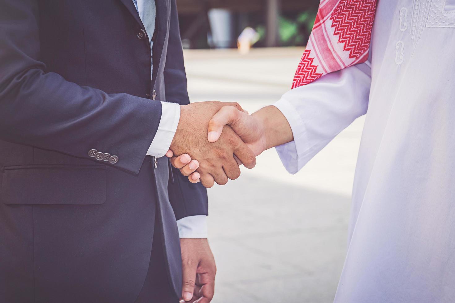 Arabic businessman giving an handshake to his business partner, on construction site photo