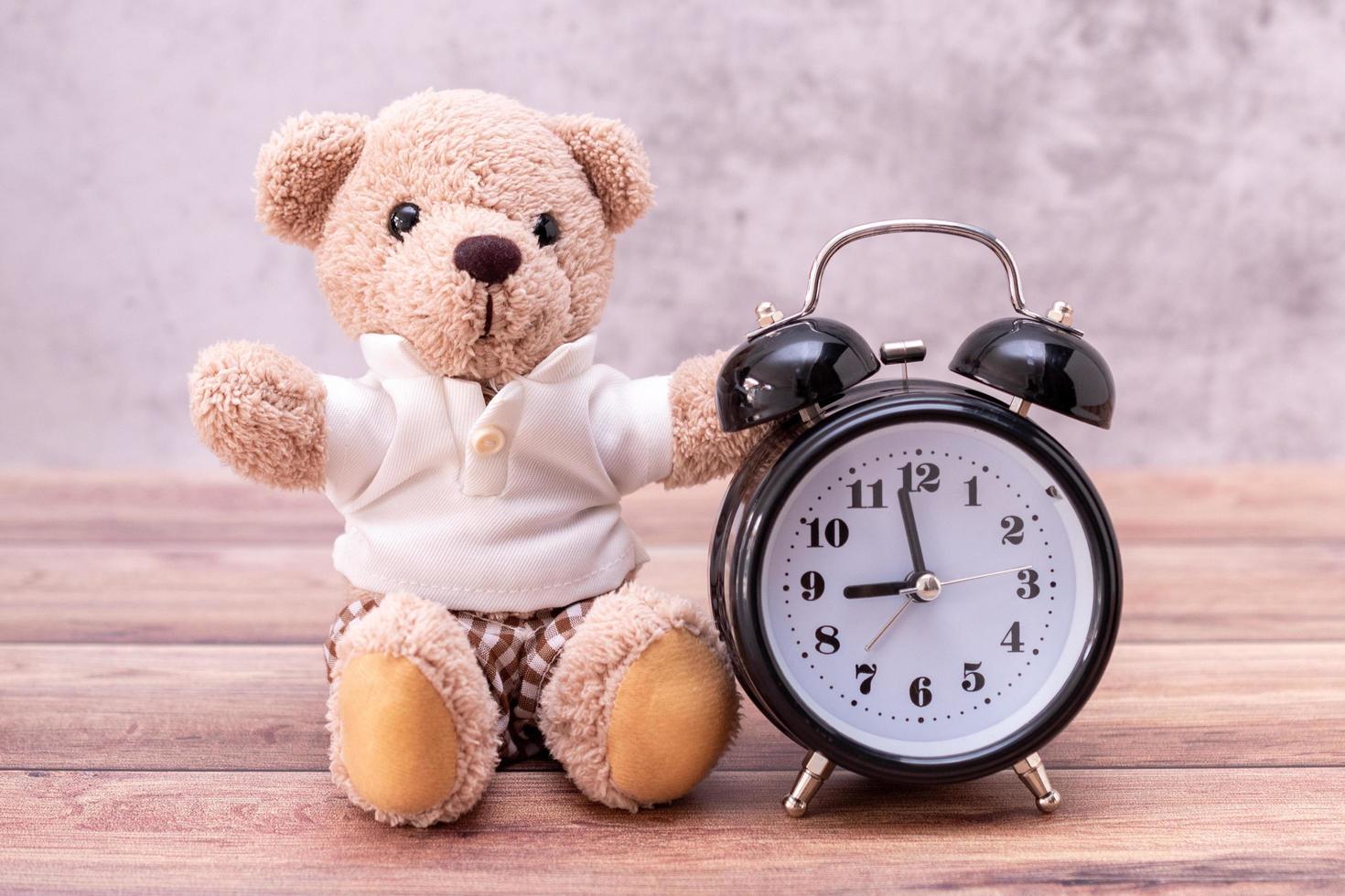 teddy bear and clock on table wooden. Valentine's Day celebration photo