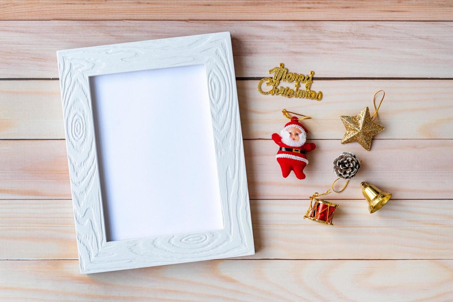 Picture frame and Christmas decoration - Santa Clause and gift on wooden table. Christmas and Happy new year concept photo