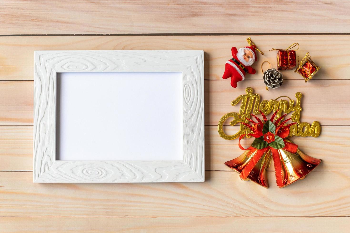 Picture frame and Christmas decoration - Santa Clause and gift on wooden table. Christmas and Happy new year concept photo