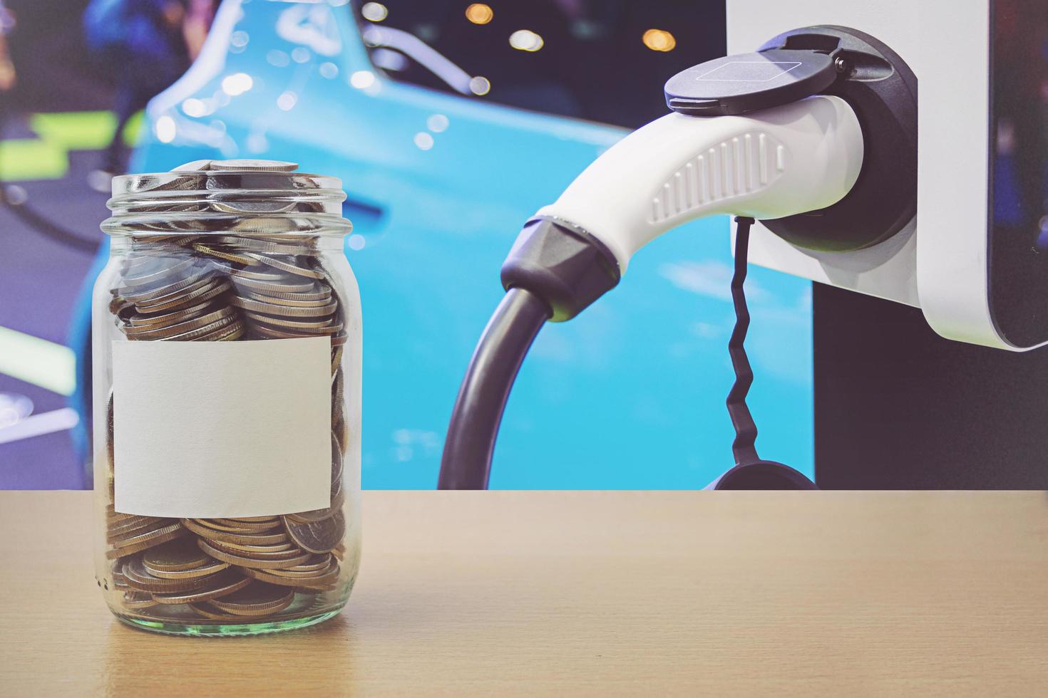 Money bottle with coins, Charging an electric car battery background photo