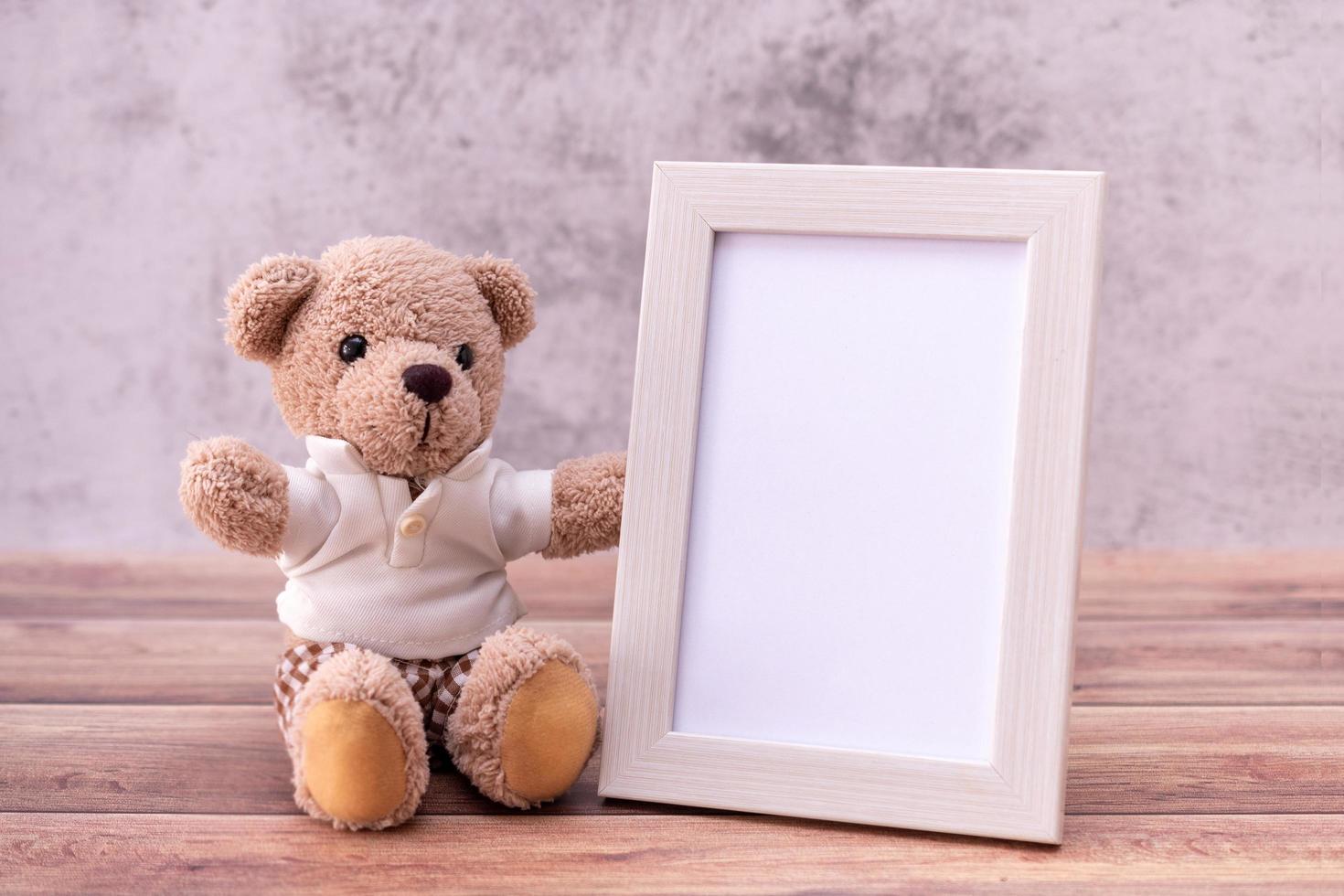 teddy bear with Picture frame on table wooden. Valentine's Day celebration photo