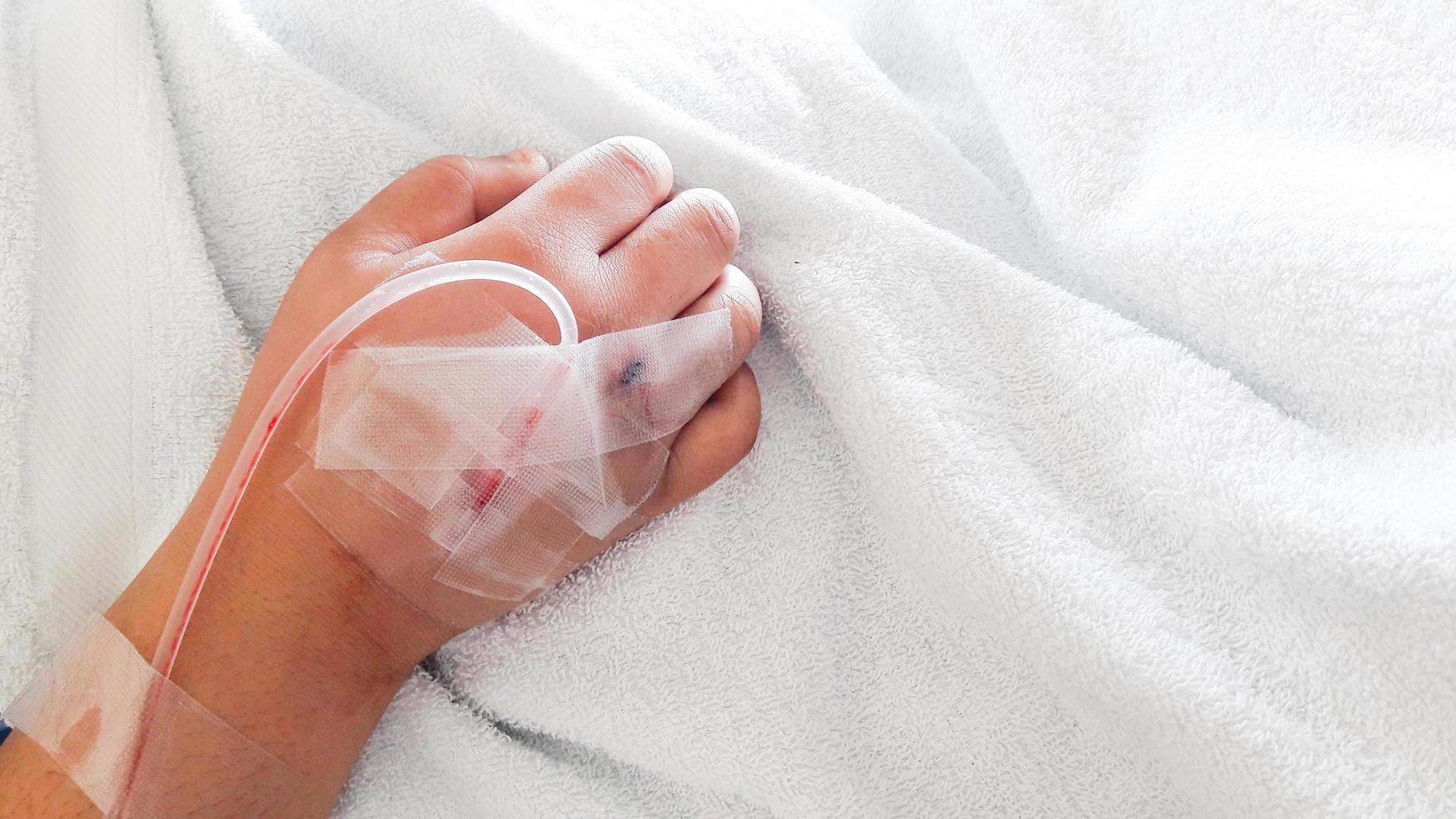 Closeup saline water line on a hand photo