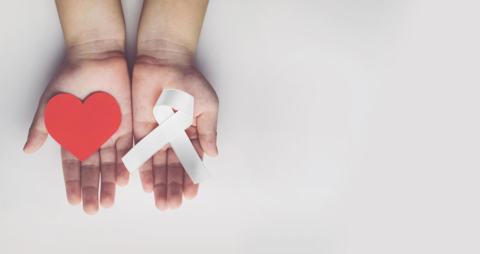 Child holding white ribbon. violence against children and women photo