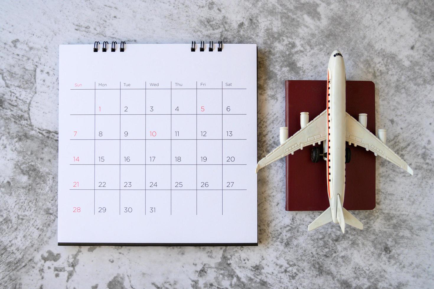 Airplane model with paper calendar. plan for trip photo