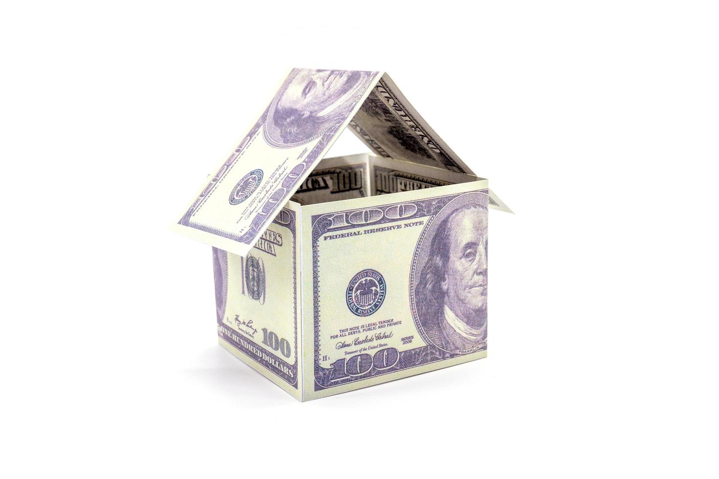 House made of cash Dollar money isolated on white background. photo