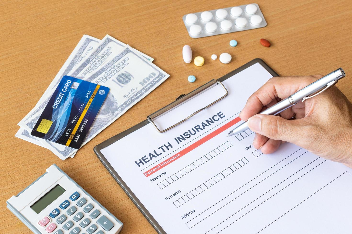 Health insurance form with model and policy document photo