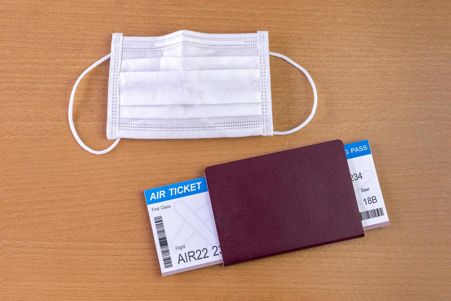 Travel during the covid-19 pandemic. airplane model with face mask, air ticket and passport. ready for holidays. photo