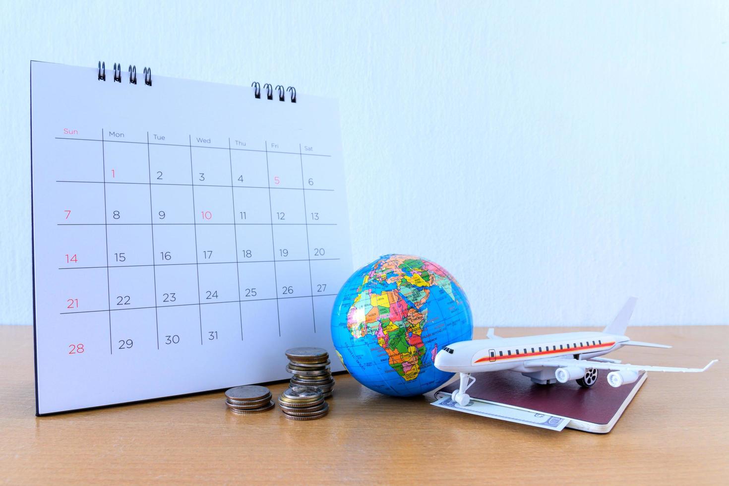 Airplane model with paper calendar on wooden table. plan for trip photo