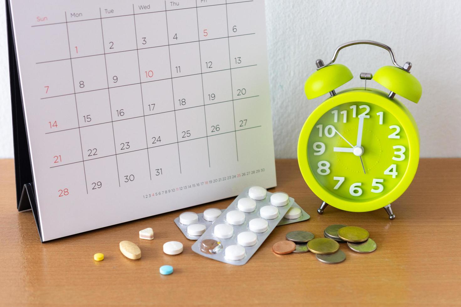 Calendar and drugs on table. photo