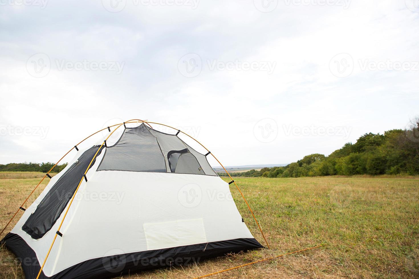 Installed tourist tent in nature in the forest. Domestic tourism, active summer holidays, family adventures. Ecotourism, social distance. Copy space photo