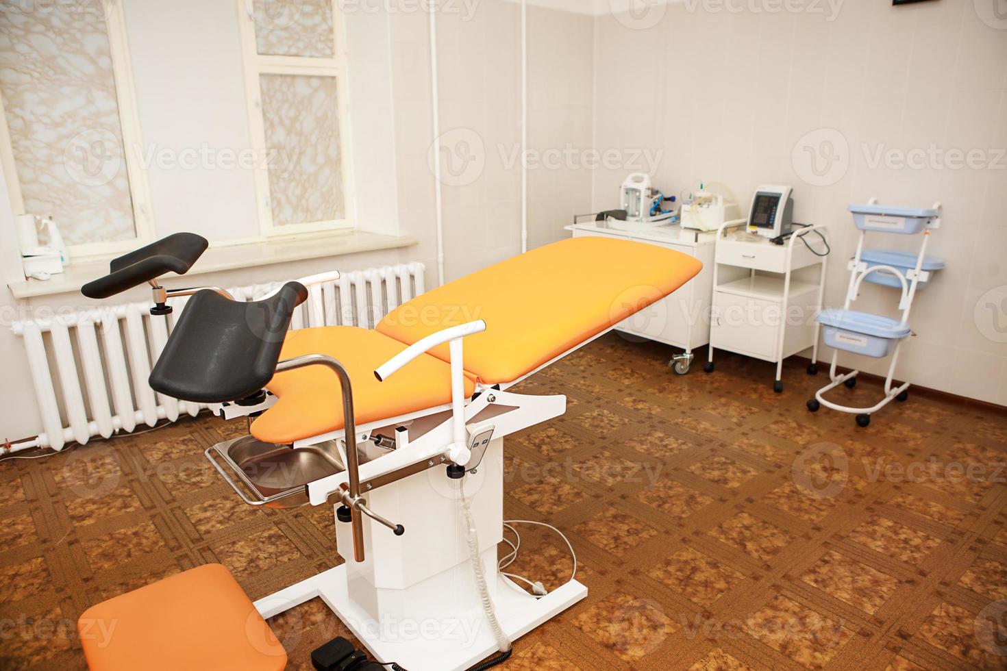 Gynecological chair in the clinic for artificial insemination and reproduction of women. Couch and medical equipment for examination, termination of pregnancy, embryo implantation photo