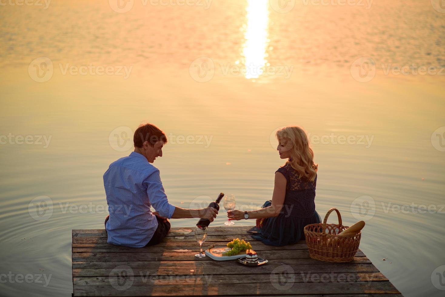 Man and woman on the pier near the lake. photo