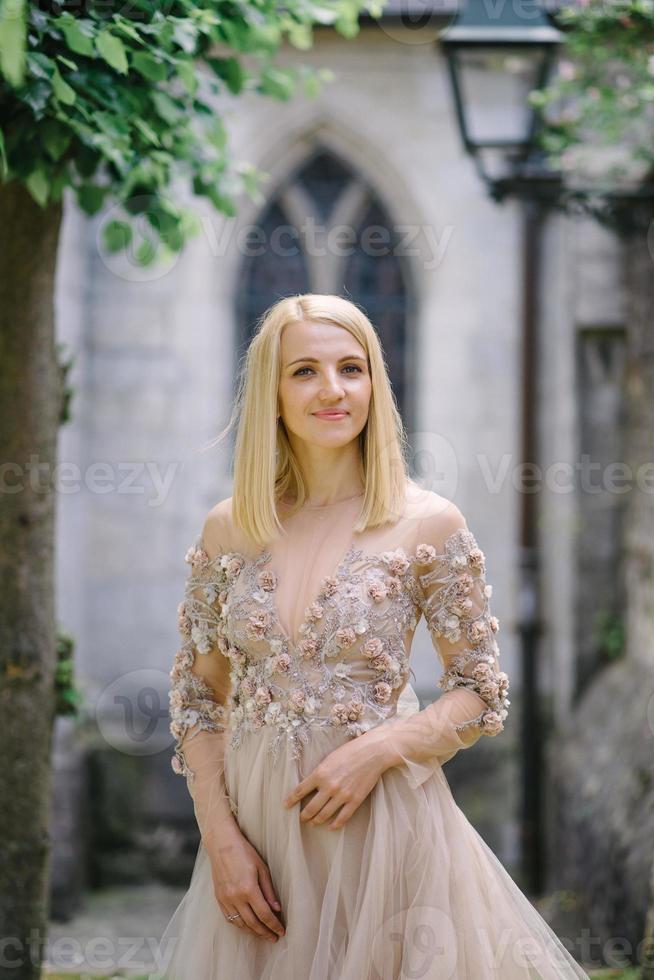 a trendy young couple walks in the city in summer, the young woman wears a luxury. photo