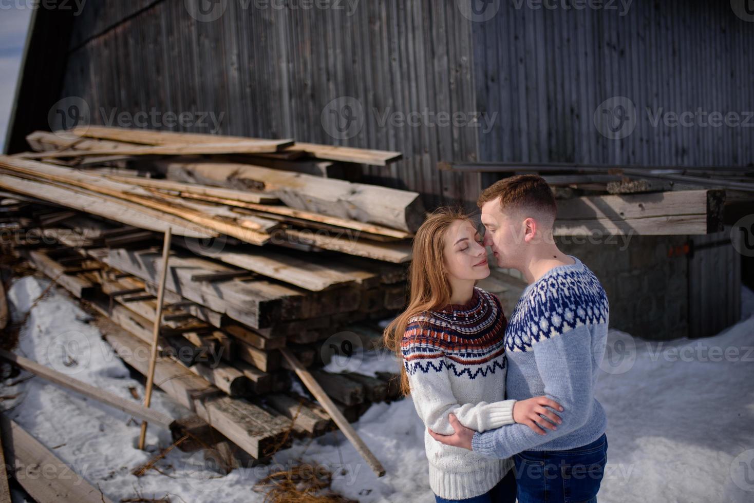 outdoor fashion portrait of young sensual couple in cold winter weather. love and kiss photo