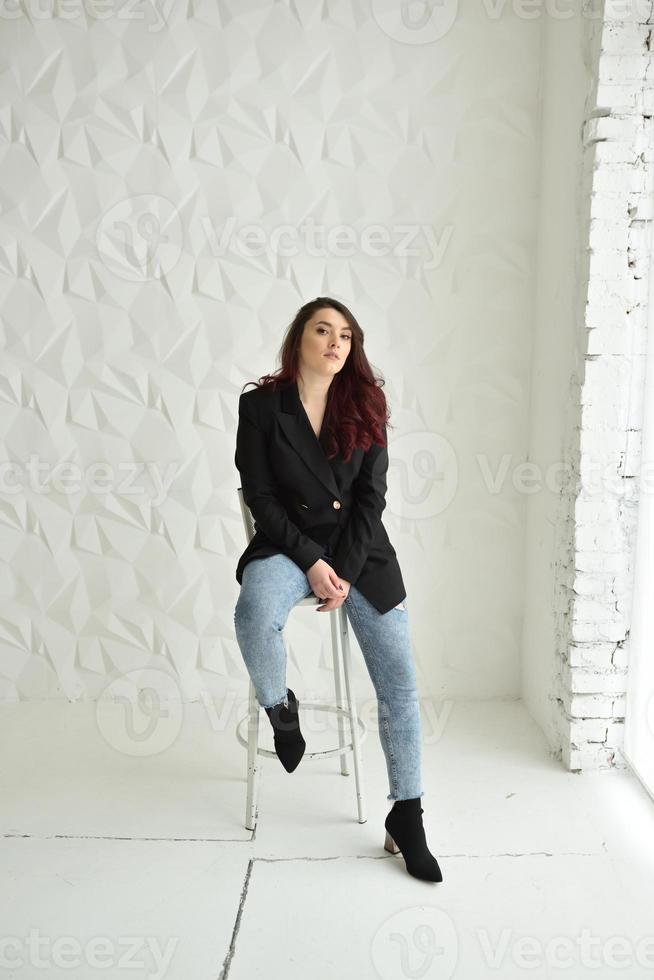 Attractive Young Woman Sitting in Chair photo