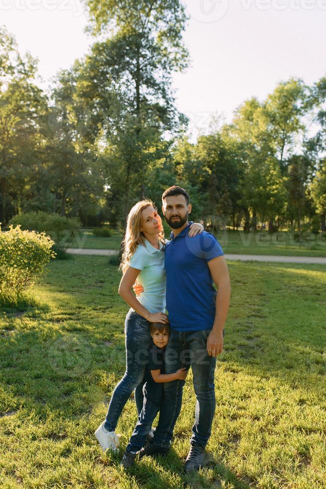 Parents play in the park with their son photo