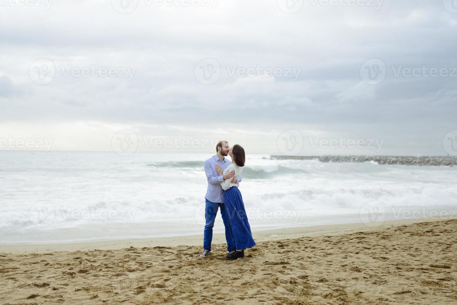 A loving couple, man and woman enjoying summer vacation on a tropical paradise beach with clear sea ocean water and scenic photo