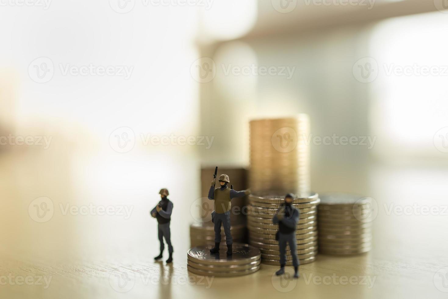 Business, Finance Security Concept. Close up of group of soldier miniature figure standing and guard with stack of coins with copy space. photo