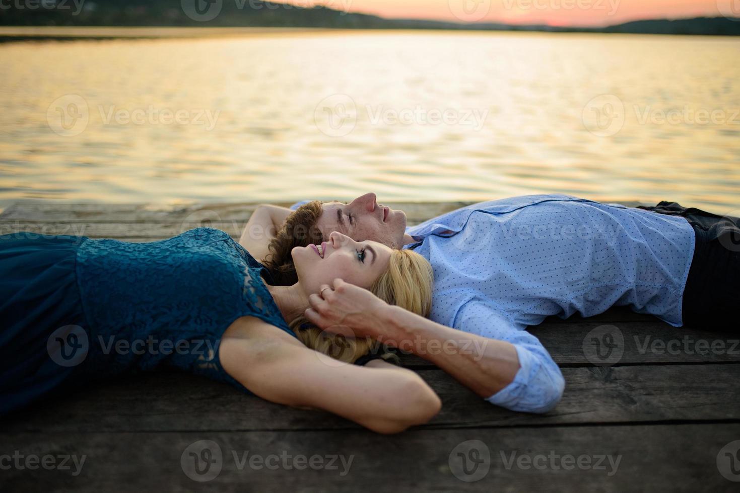 Man and woman on the pier near the lake. photo