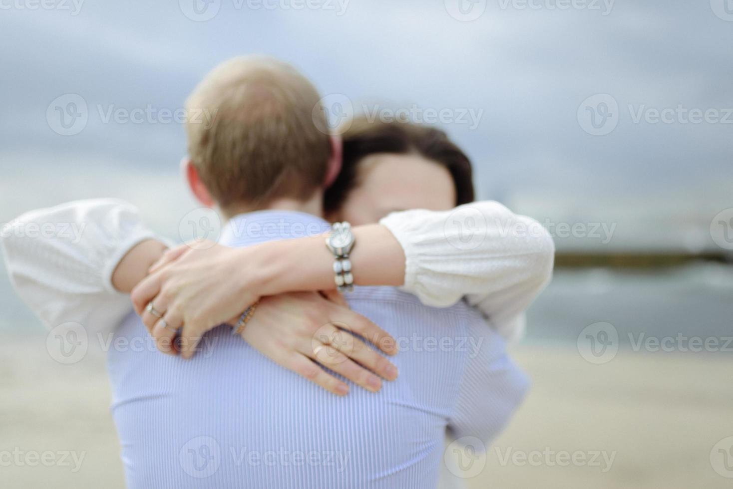 A loving couple, man and woman enjoying summer vacation on a tropical paradise beach with clear sea ocean water and scenic photo