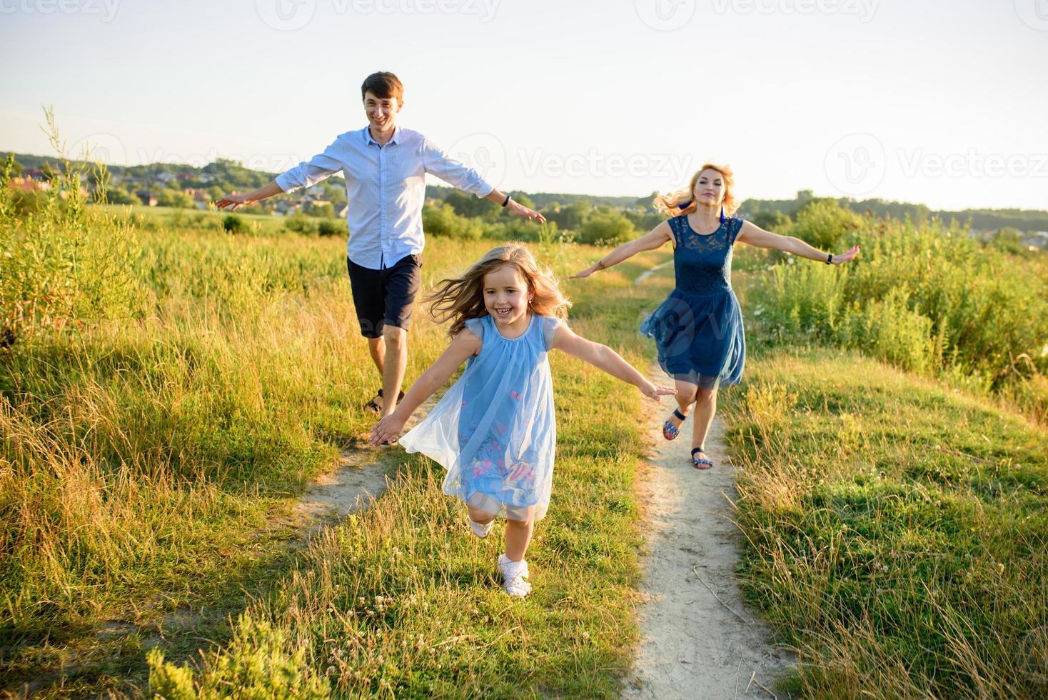 Dad mom and daughter have fun together in nature. photo