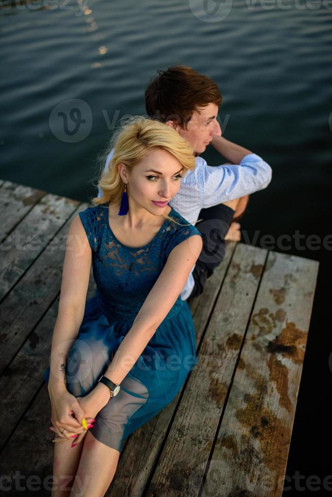 hombre y mujer en el muelle cerca del lago. foto